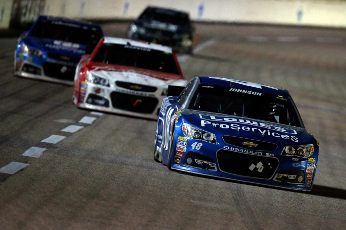 FORT WORTH, TX - APRIL 11: Jimmie Johnson, driver of the #48 Lowe's Pro Services Chevrolet, leads a pack of cars during the NASCAR Sprint Cup Series Duck Commander 500 at Texas Motor Speedway on April 11, 2015 in Fort Worth, Texas. (Photo by Tom Pennington/Getty Images for Texas Motor Speedway)