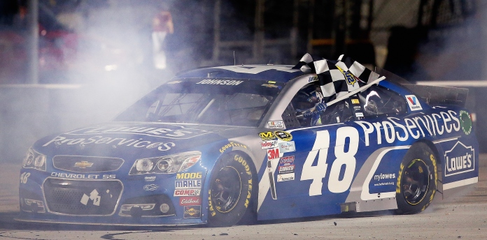 FORT WORTH, TX - APRIL 11: Jimmie Johnson, driver of the #48 Lowe's Pro Services Chevrolet, celebrates with the checkered flag after winning the NASCAR Sprint Cup Series Duck Commander 500 at Texas Motor Speedway on April 11, 2015 in Fort Worth, Texas. (Photo by Tom Pennington/Getty Images for Texas Motor Speedway)