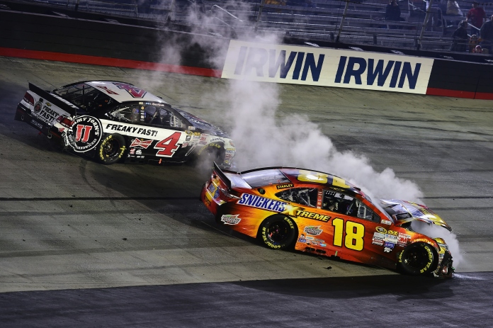 :BRISTOL, TN - APRIL 19: Kevin Harvick, driver of the #4 Jimmy John's/Budweiser Chevrolet, and David Ragan, driver of the #18 Snickers Xtreme Toyota, are involved in an on track incident during the NASCAR Sprint Cup Series Food City 500 at Bristol Motor Speedway on April 19, 2015 in Bristol, Tennessee. (Photo by Jared C. Tilton/Getty Images)