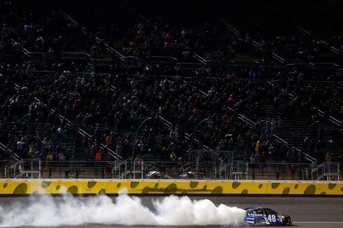 KANSAS CITY, KS - MAY 09: Jimmie Johnson, driver of the #48 Lowe's Chevrolet, celebrates with a burnout after winning the NASCAR Sprint Cup Series SpongeBob SquarePants 400 at Kansas Speedway on May 9, 2015 in Kansas City, Kansas. (Photo by Jonathan Ferrey/Getty Images)