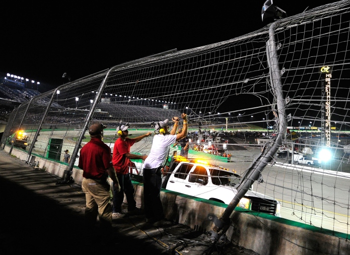 Sparta, KY - JULY 9: Track official check the damage to the fence after Ben Kennedy, driver of the #11 Local Motors Toyota, crashed into it during the NASCAR Camping World Truck Series UNOH 225 at Kentucky Speedway on July 9, 2015 in Sparta, Kentucky.  (Photo by Jeff Curry/Getty Images)