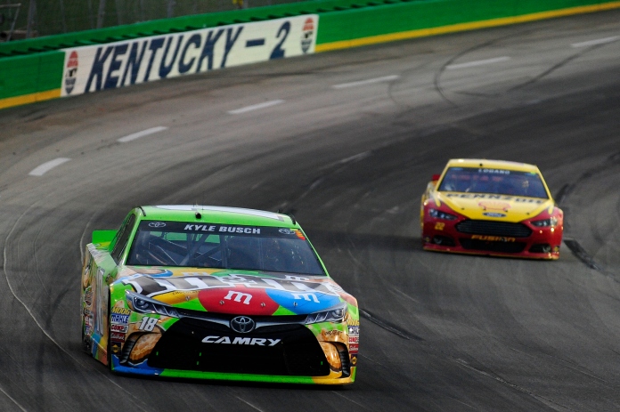 SPARTA, KY - JULY 11:  Kyle Busch, driver of the #18 M&M's Crispy Toyota, leads Joey Logano, driver of the #22 Shell Pennzoil/AutoTrader Ford, during the NASCAR Sprint Cup Series Quaker State 400 presented by Advance Auto Parts at Kentucky Speedway on July 11, 2015 in Sparta, Kentucky.  (Photo by Jeff Curry/Getty Images)